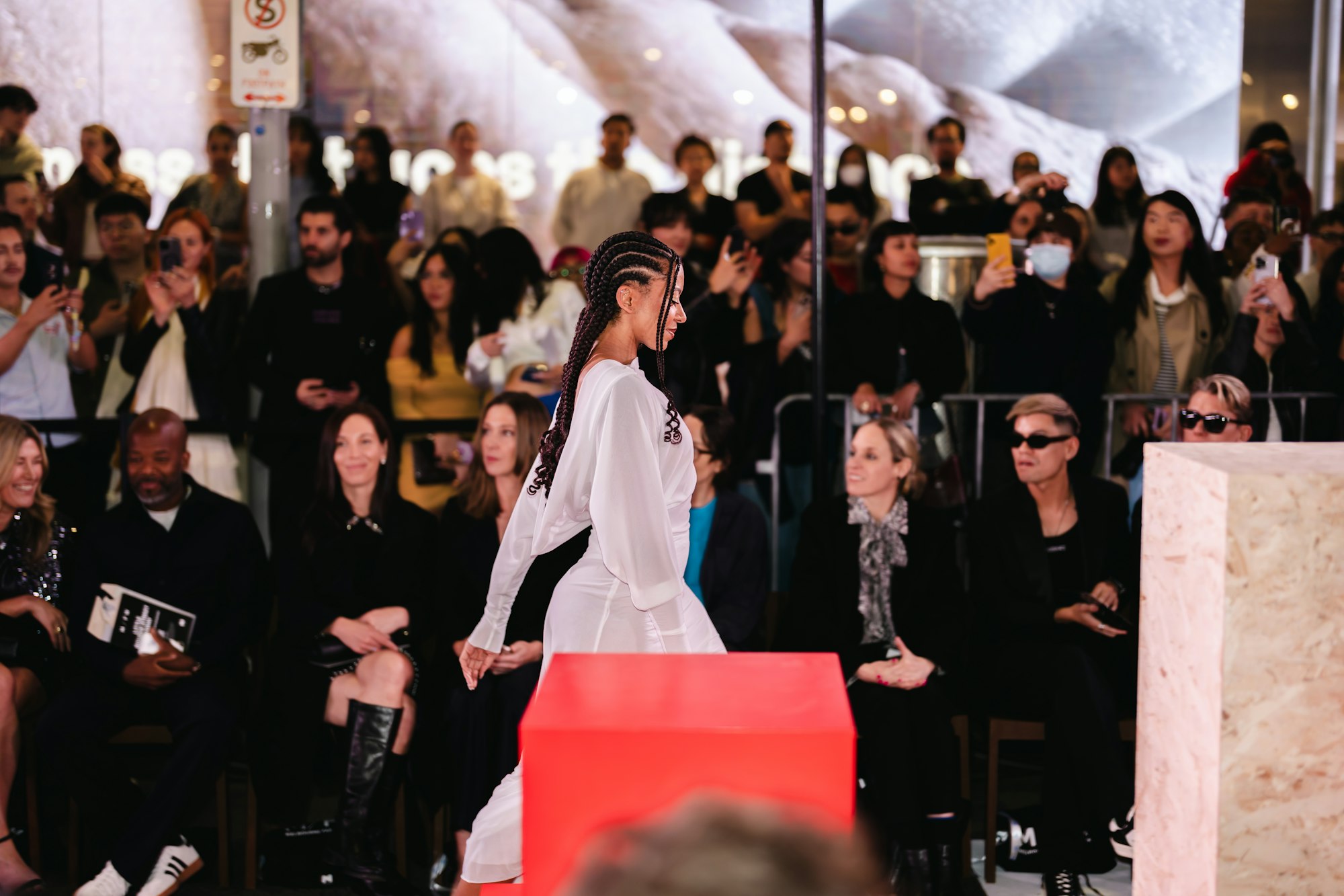Fashion show: a model on the runway passing the front row